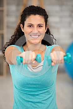 strong woman working out with dumbbells