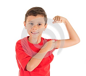 Strong young boy showing his left hand biceps muscle