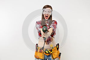 Strong young energy handyman woman in plaid top shirt denim shorts kit tools belt full of instruments in protective