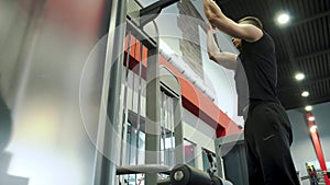 Strong Young Handsome Male Athlete Engaged With Exercise Machine In The Gym