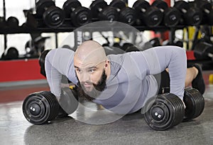 Strong young man doing push-ups, building muscles, living active healthy life