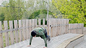 Strong young man doing push ups. Male athlete sportsman workout training outdoors summer doing push up exercises