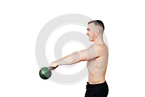 Strong young man swinging a kettlebell. Strength and motivation.