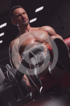 Strong young man working out in the gym