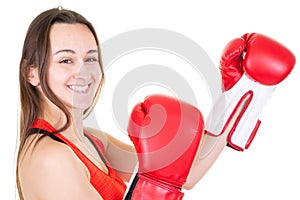 Strong young woman boxer in isolated whitenbackground wall wearing red boxing gloves