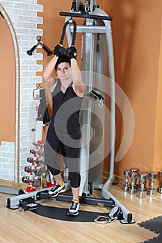 Strong young woman in gym