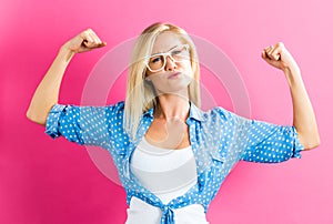 Strong young woman on pink background