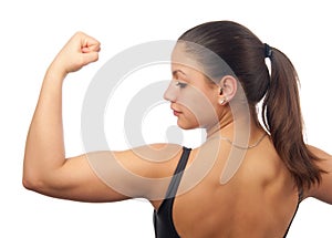 Strong young woman showing her muscles