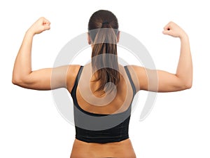 Strong young woman showing her muscles