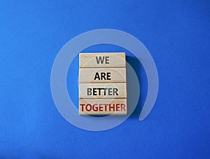 We are stronger together symbol. Wooden blocks with words We are stronger together. Beautiful blue background. We are stronger