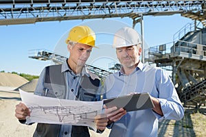 Structural engineers with plans and tablet