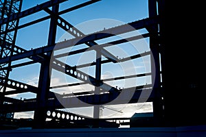 Structural steel girders framed in silhouette.