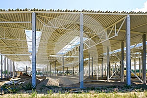 The structural steel structure of a new commercial building on reinforced concrete supports