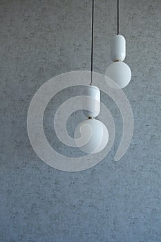 The structure of concrete is gray. Creative vintage background. Structural plaster. Modern lights in the form of a white ball on a