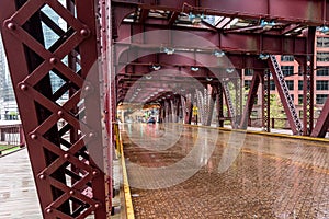 Structure of a double deck bridge spanning the river in downtown Chicago on a rainy day