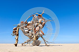 Construction of dry twigs and driftwood with colored stones in the desert.