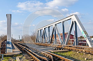 Structure of gray metal railway bridge for train in a sunny day.