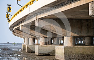 Structure of reinforced concrete bridge along the sea. Bottom view of concrete bridge. Concrete bridge engineering construction.