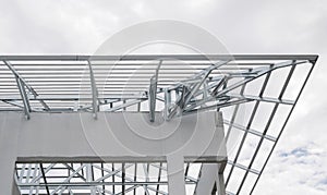Structure of steel roof frame with blue sky and clouds