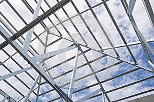 Structure of steel roof frame with blue sky at constr