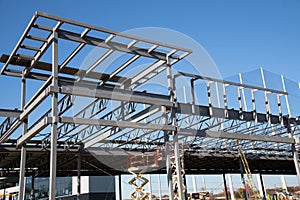 structure of steel roof frame for building construction on sky background