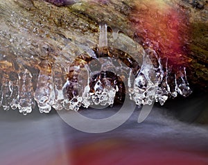 Structured ice above a motion blur water stream