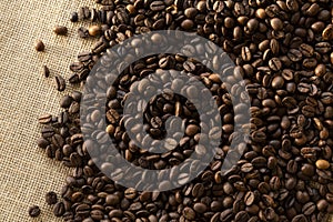 Structured linen background with roasted coffee beans