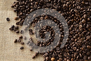 Structured linen background with roasted coffee beans