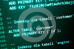 Structured sql code on monitor. SQL code on a dark background development concept
