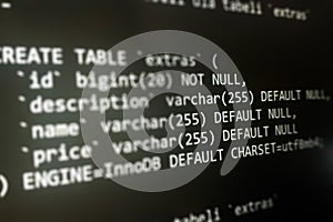 Structured sql code on monitor. SQL code on a dark background development concept