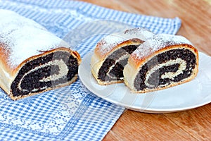 Strudel with poppy seeds on table