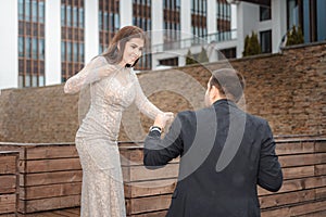 The struggle between a man and a woman. a young couple is fighting. females in evening dress is fought by a guy