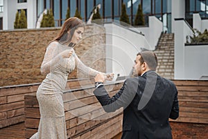 The struggle between a man and a woman. a young couple is fighting. females in evening dress is fought by a guy