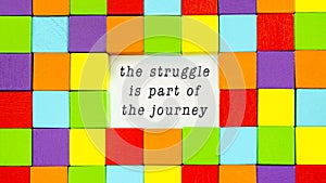 The Struggle is Part of the Journey typed on paper in a conceptual image of inspiration and motivation