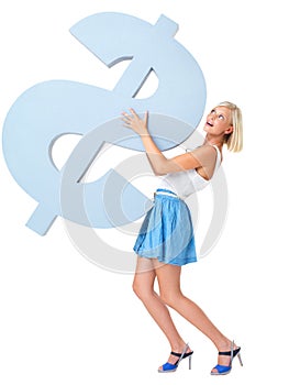 Struggling to carry cash pressures. Young woman carrying a large, heavy, blue dollar sign.