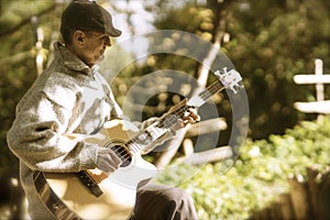 Strumming guitar in afternoon light