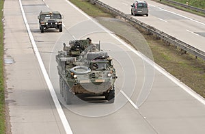 Stryker,wheeled armored vehicle drives on highway . photo