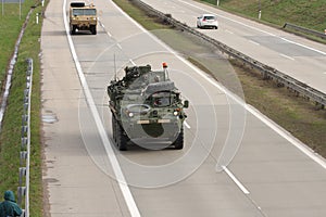 Stryker,wheeled armored vehicle drives on highway . photo