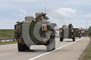 Strykers,wheeled armored vehicles drive on highway . photo