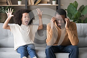 Stubborn african child girl in tantrum screaming at black father