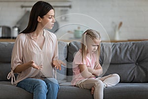 Stubborn upset little daughter ignoring strict mother, family conflict