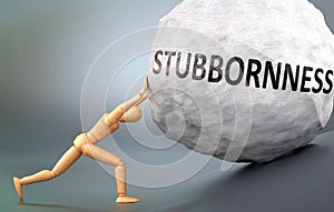 Stubbornness and painful human condition, pictured as a wooden human figure pushing heavy weight to show how hard it can be to