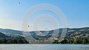 Stubenberg - Two colorful hot air balloons float gracefully above bathing lake Stubebergsee photo