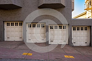Stucco Building With Four Garage Doors Going Down Hill