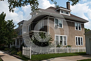 Stucco House with Picket Fence