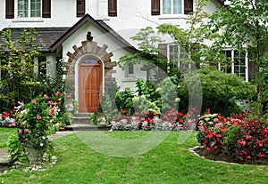 Stucco house with flowers in front yard