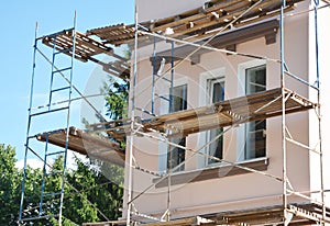 Stucco, Painting and Plastering Exterior House Scaffolding Facade Wall.