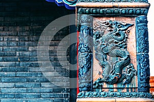 The stucco prints a dragon pattern on the brick wall in Shenyang Imperial Palace in CHINA