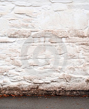 Stucco white wall in autumn