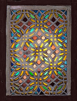 Stucco window decorated with colorful stain glass with geometrical circular patterns, an Ottoman era tradition